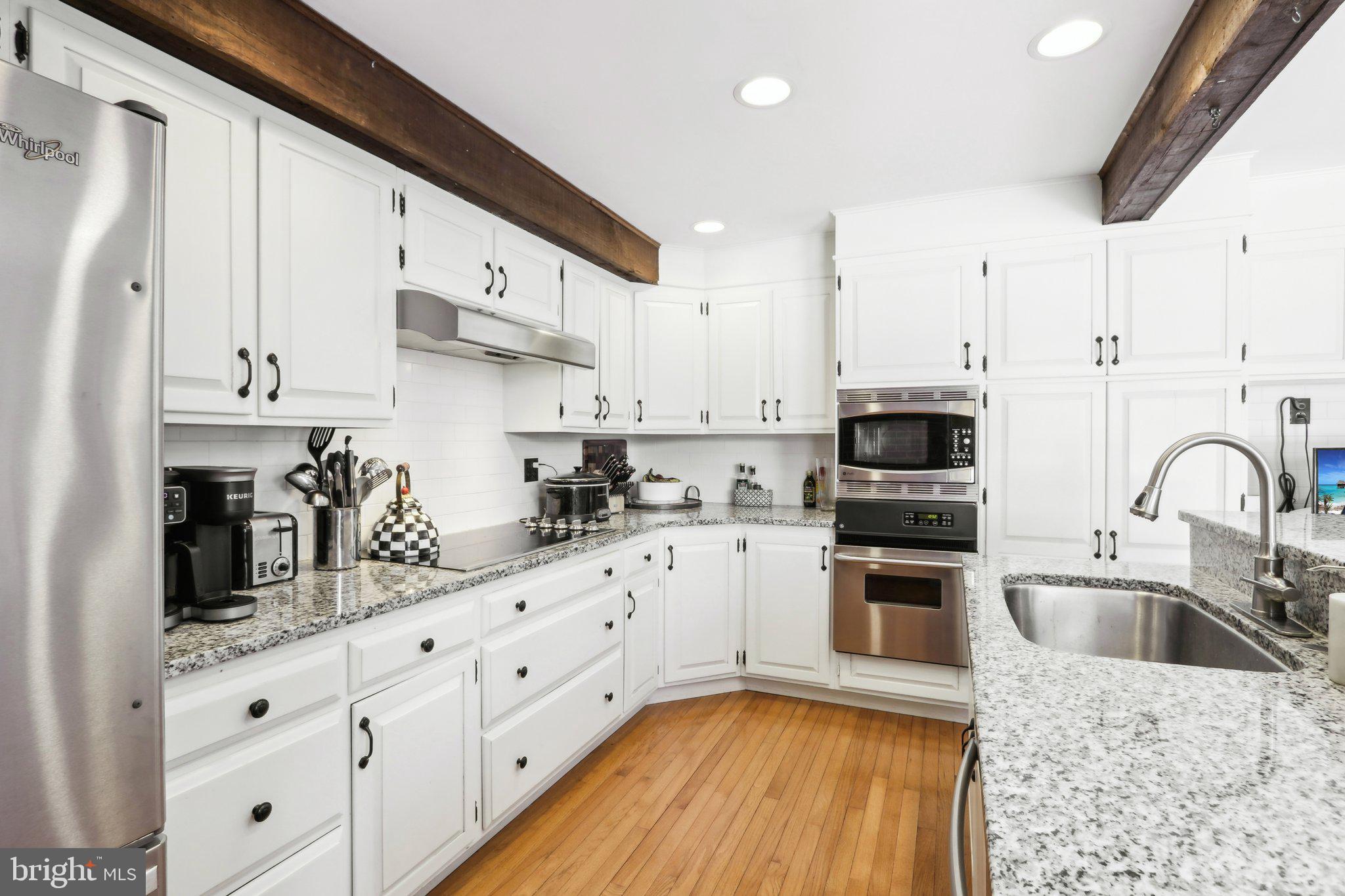 416 Dutton Mill Road Malvern, PA 19355 - Photo 14 of 56 a kitchen with stainless steel appliances granite countertop a sink a stove and refrigerator