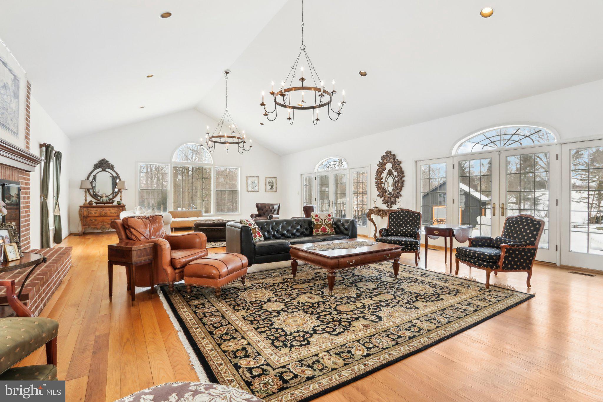 416 Dutton Mill Road Malvern, PA 19355 - Photo 19 of 56 a living room with furniture a rug and a chandelier