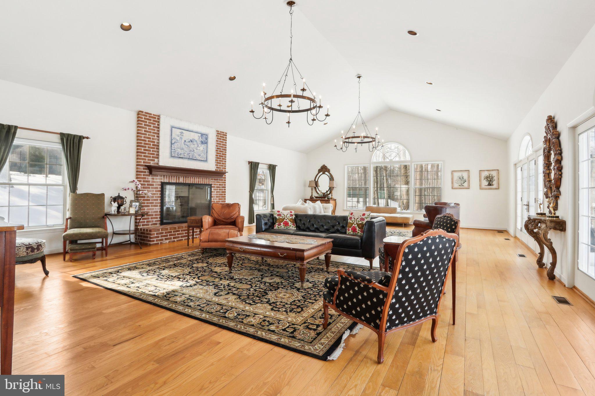 416 Dutton Mill Road Malvern, PA 19355 - Photo 20 of 56 a living room with fireplace furniture and a chandelier