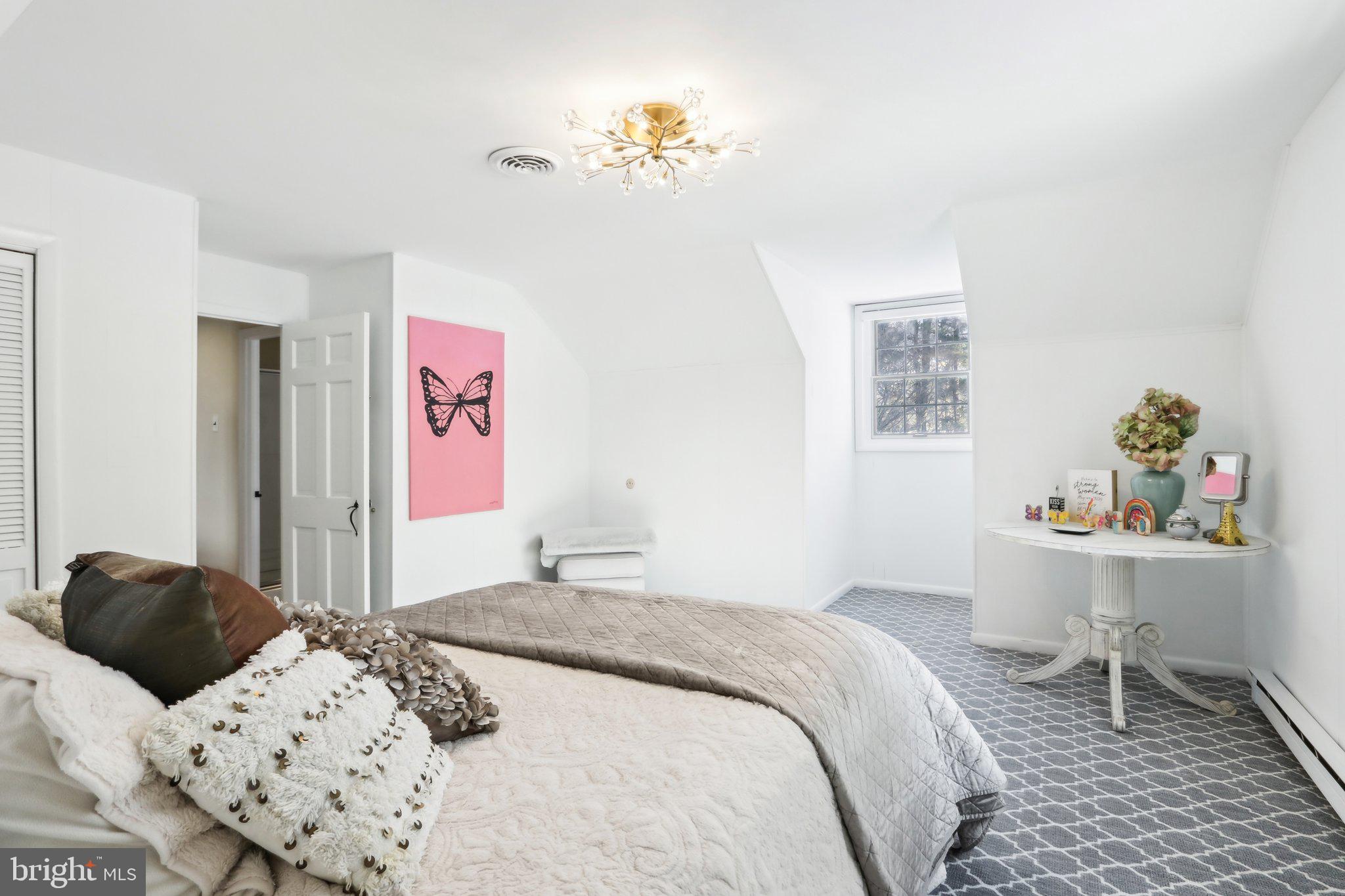 416 Dutton Mill Road Malvern, PA 19355 - Photo 32 of 56 a bedroom with a bed and a table in it