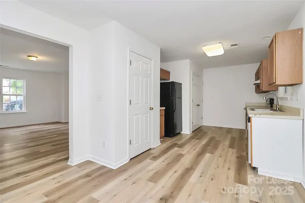 a view of a kitchen with a sink and a refrigerator