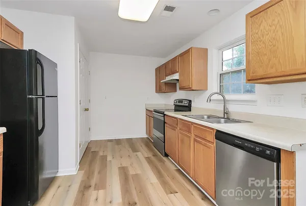 a kitchen with a sink a refrigerator freezer a washer and dryer