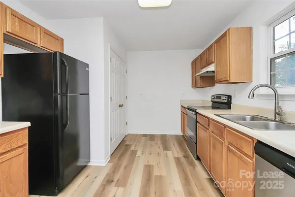 a kitchen with a sink and a refrigerator