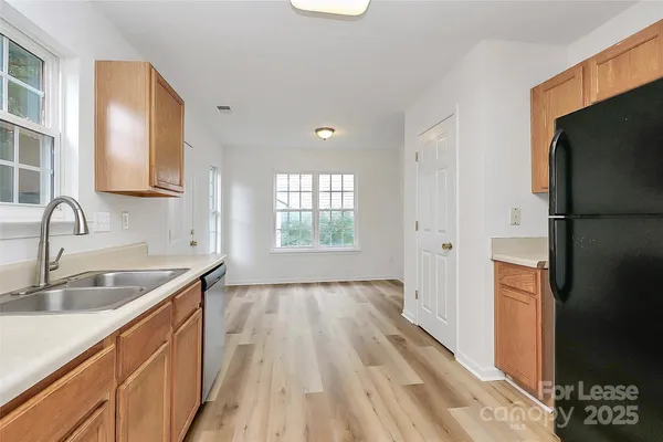 a kitchen with a sink stove and refrigerator