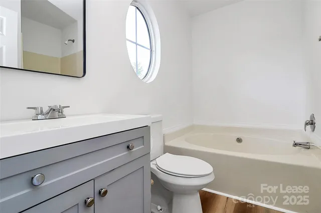 a bathroom with a sink a toilet and bathtub