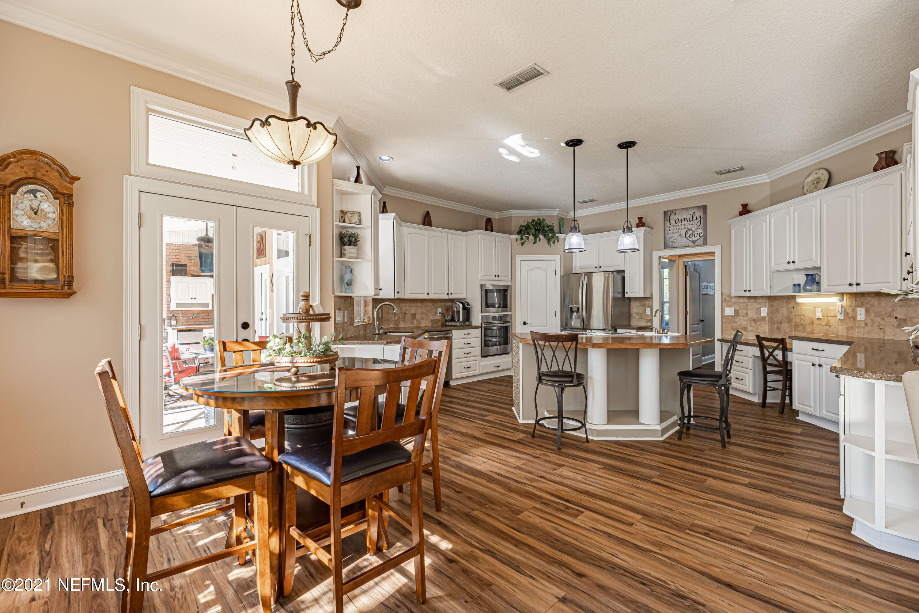 1827 Wild Grape Lane Fleming Island, FL 32003 - Photo 11 of 51 a view of a dining room with furniture and wooden floor
