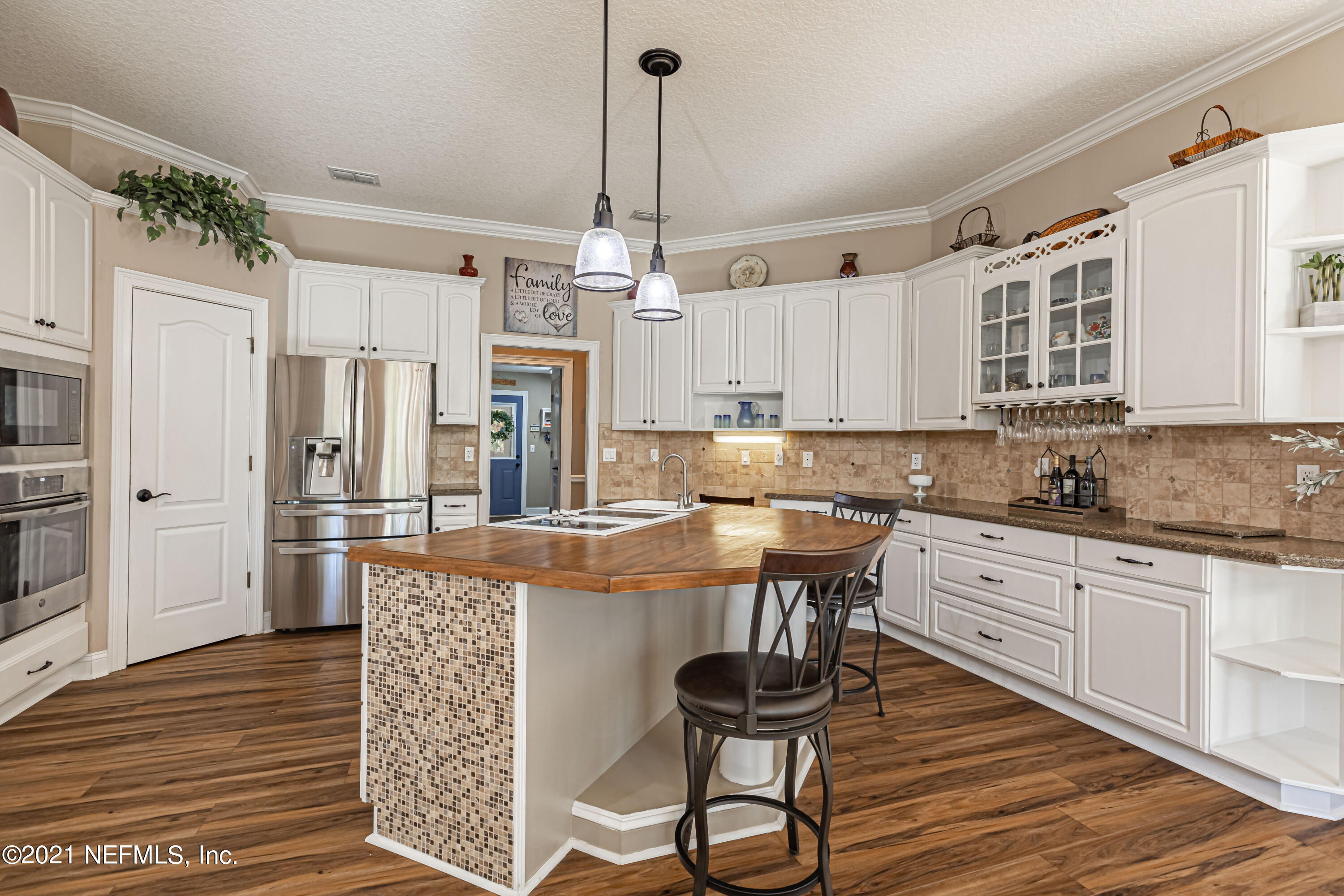 1827 Wild Grape Lane Fleming Island, FL 32003 - Photo 12 of 51 a kitchen with stainless steel appliances granite countertop a sink refrigerator and cabinets