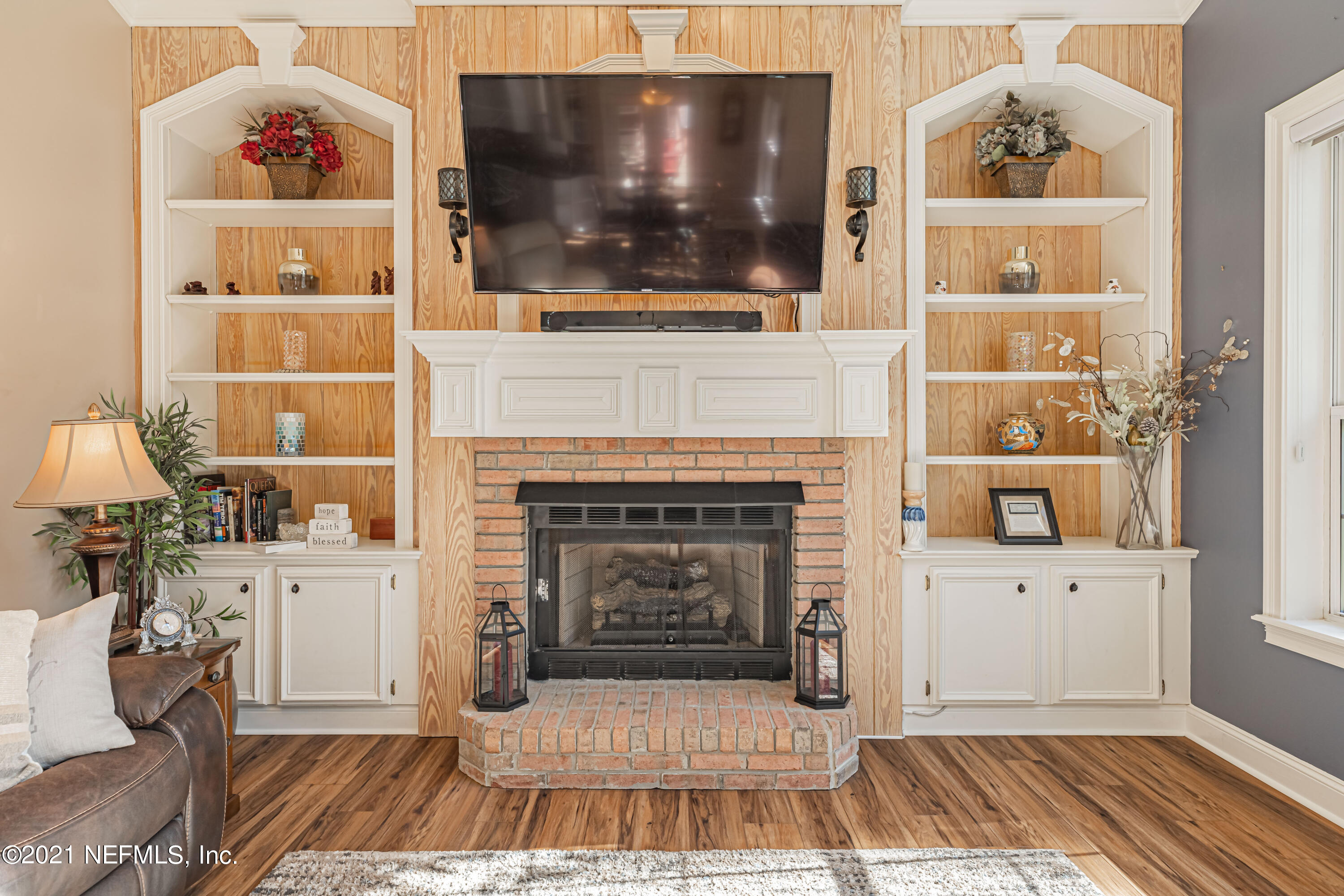 1827 Wild Grape Lane Fleming Island, FL 32003 - Photo 19 of 51 a living room with a fireplace furniture and a flat screen tv