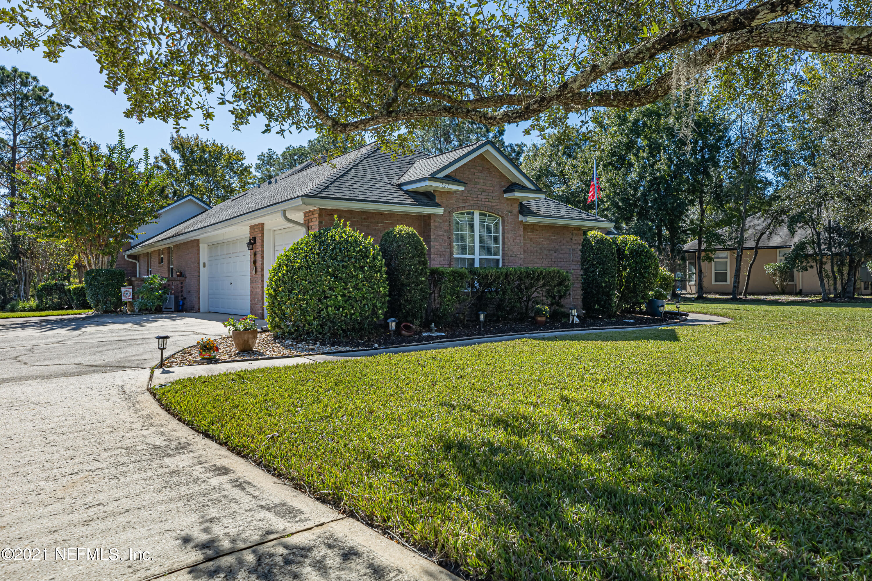 1827 Wild Grape Lane Fleming Island, FL 32003 - Photo 2 of 51 a front view of house with yard and green space