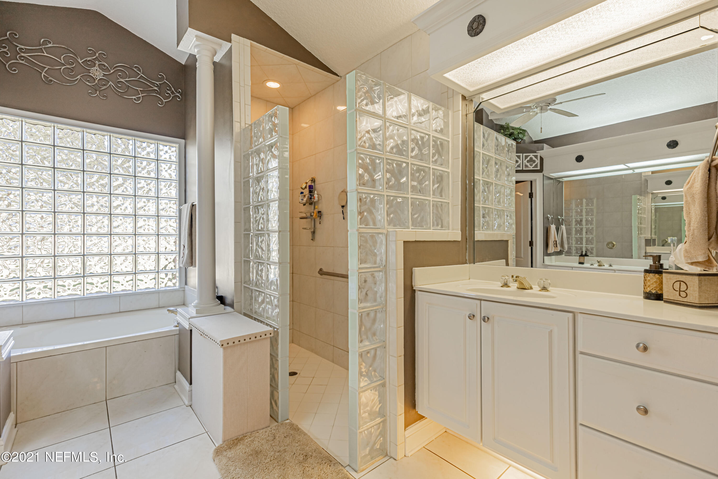 1827 Wild Grape Lane Fleming Island, FL 32003 - Photo 25 of 51 a spacious bathroom with a shower sink and mirror