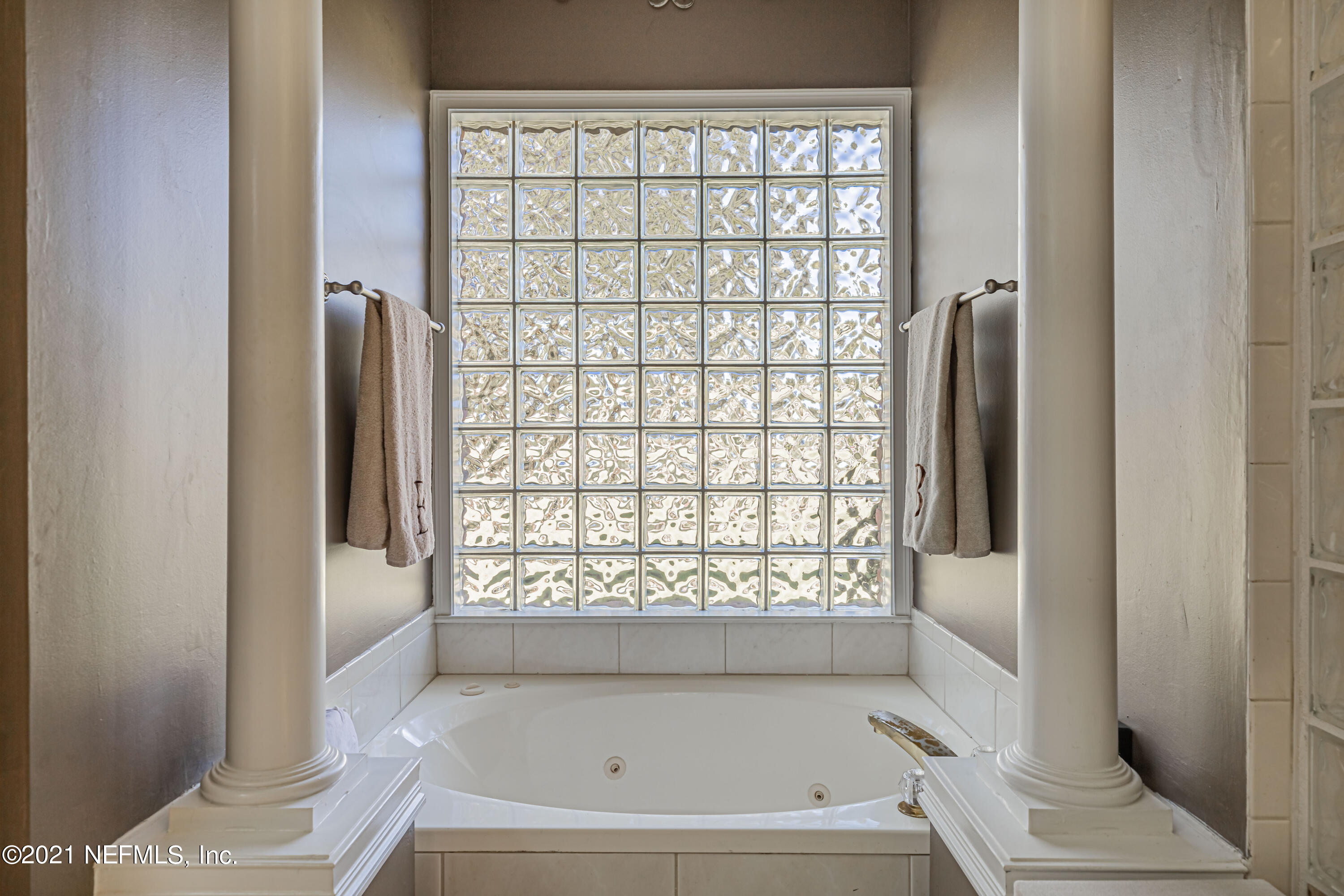 1827 Wild Grape Lane Fleming Island, FL 32003 - Photo 27 of 51 a bathroom with a bathtub and a shower