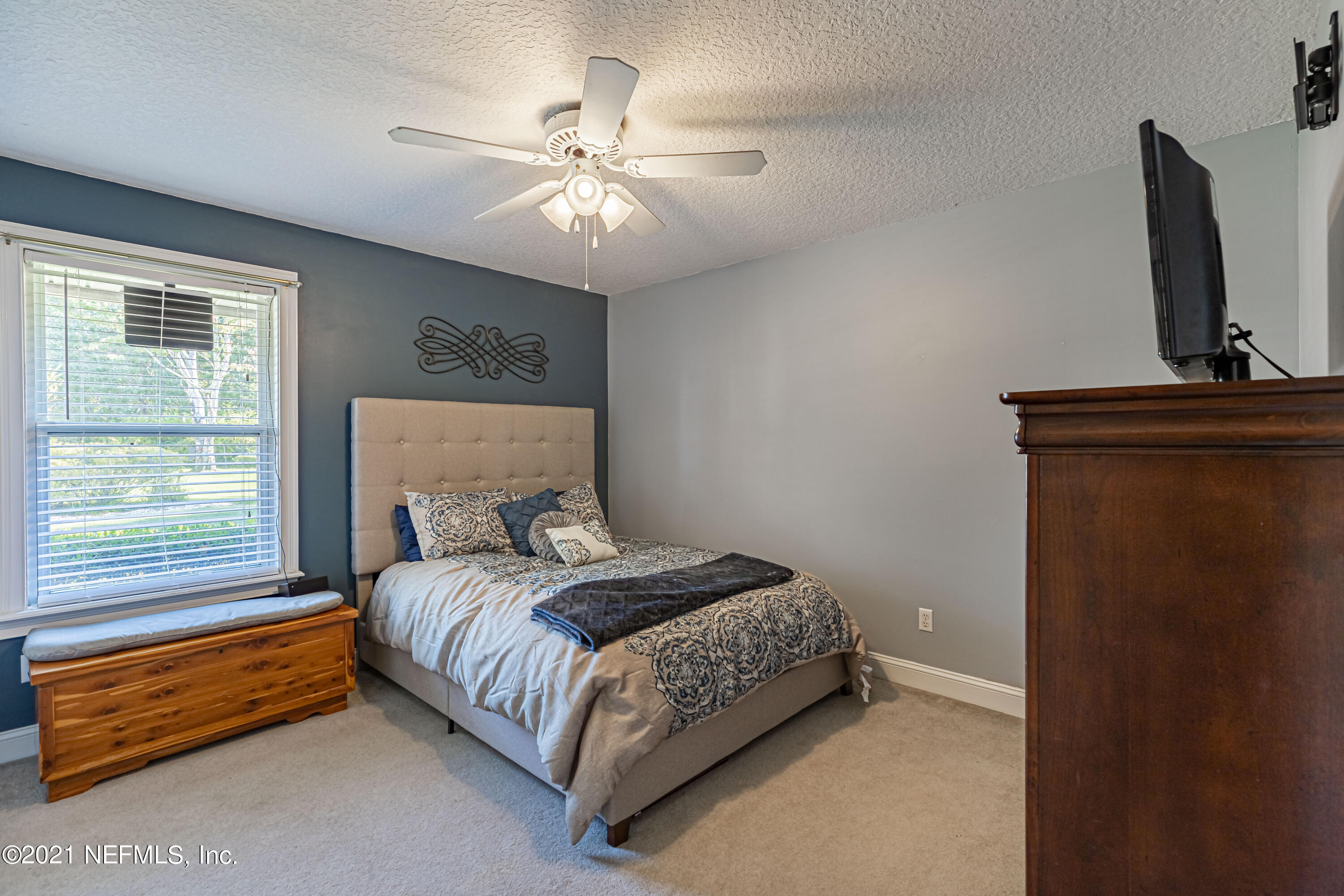 1827 Wild Grape Lane Fleming Island, FL 32003 - Photo 28 of 51 a bedroom with a bed and a window
