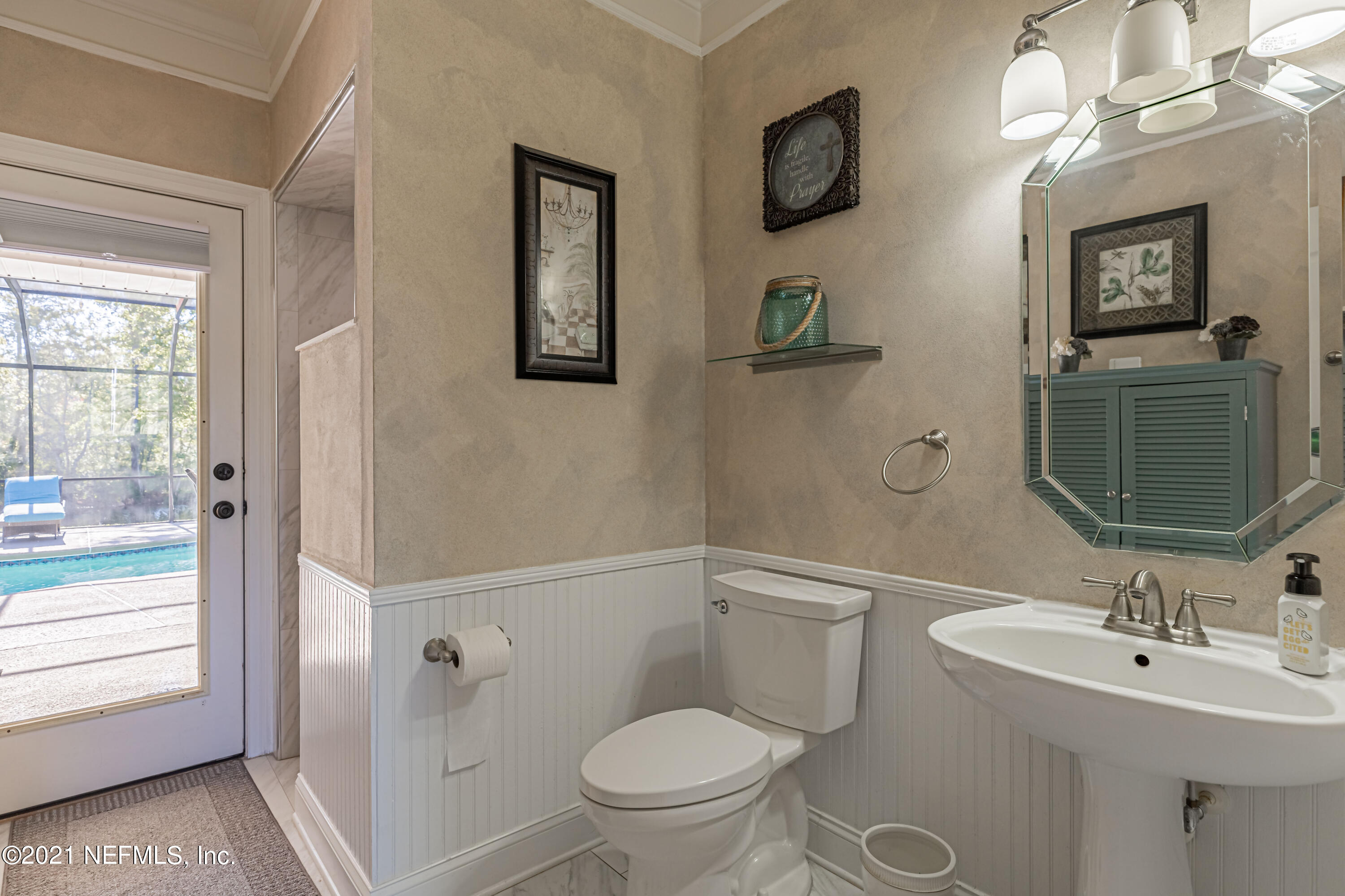 1827 Wild Grape Lane Fleming Island, FL 32003 - Photo 29 of 51 a bathroom with a toilet a sink and mirror