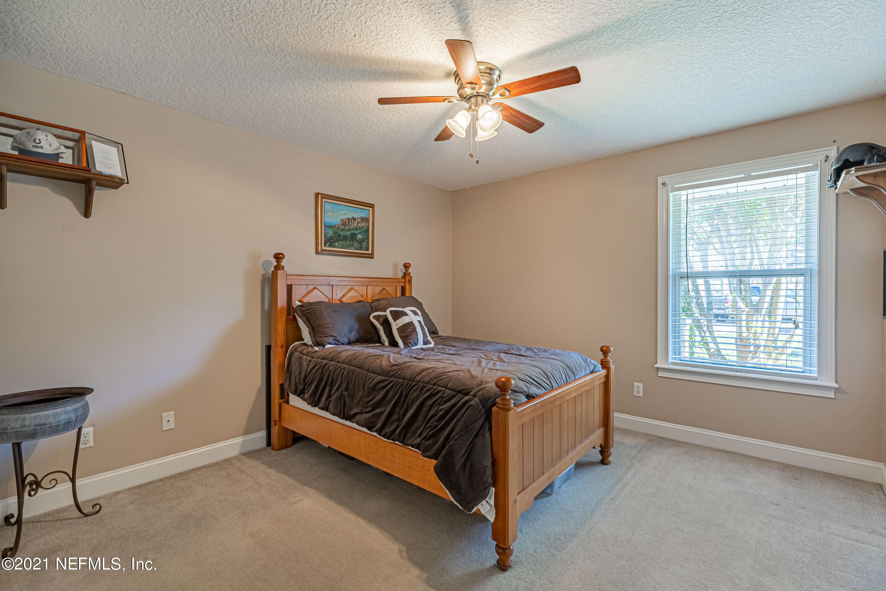 1827 Wild Grape Lane Fleming Island, FL 32003 - Photo 30 of 51 a bed sitting in a bedroom next to a window