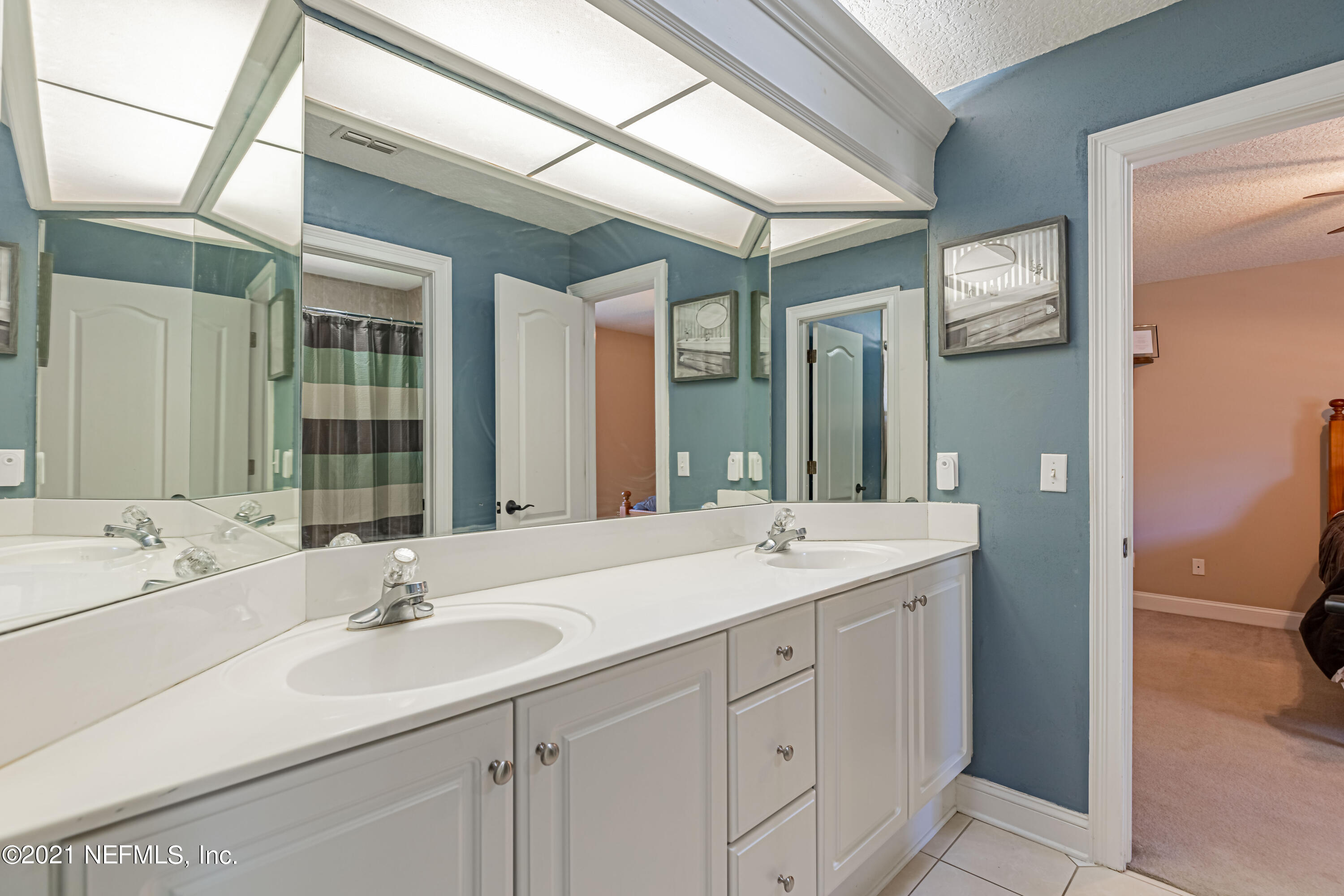 1827 Wild Grape Lane Fleming Island, FL 32003 - Photo 31 of 51 a bathroom with a sink double vanity and a mirror