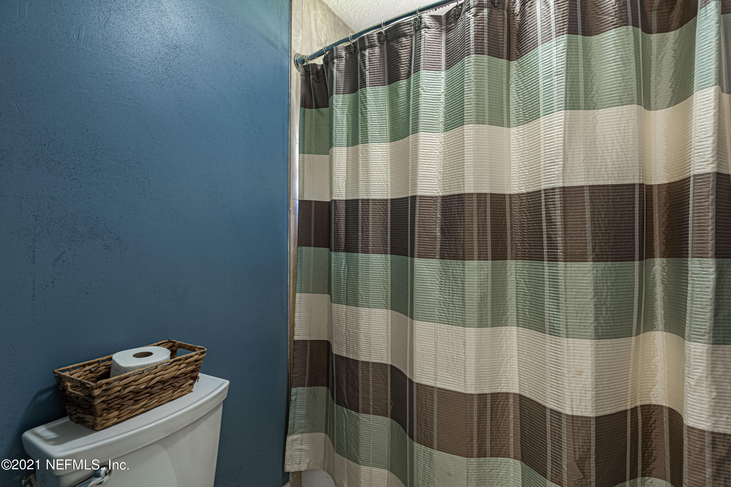 1827 Wild Grape Lane Fleming Island, FL 32003 - Photo 32 of 51 a bathroom with a sink and a shower curtain