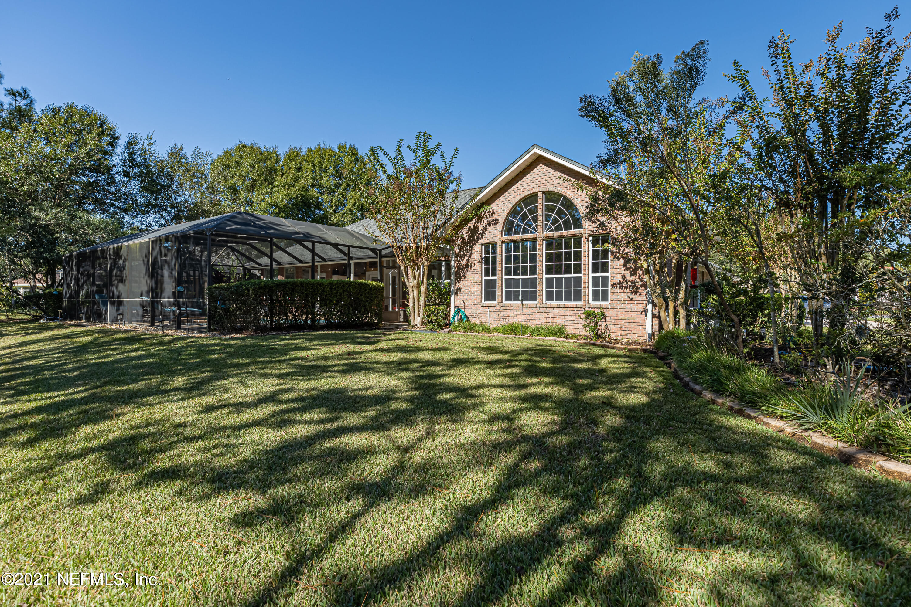 1827 Wild Grape Lane Fleming Island, FL 32003 - Photo 42 of 51 a front view of a house with a garden