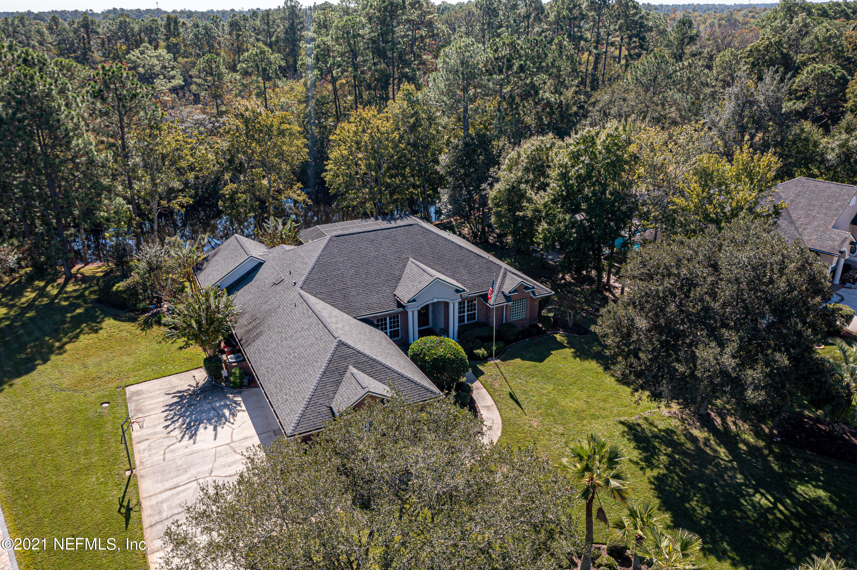 1827 Wild Grape Lane Fleming Island, FL 32003 - Photo 46 of 51 a view of a house with a yard next to a lake