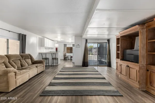 a spacious bedroom with a bed and a flat screen tv