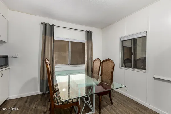 a dining room with furniture and wooden floor