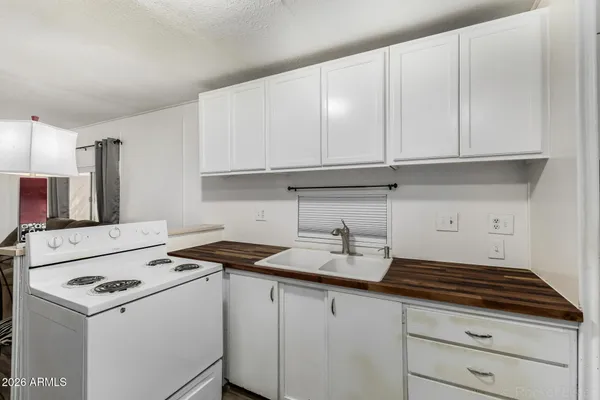 a kitchen with a sink a stove and cabinets