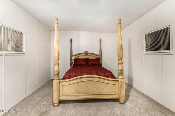a bedroom with a bed and a window