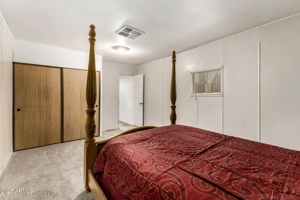 a bedroom with a bed and a closet