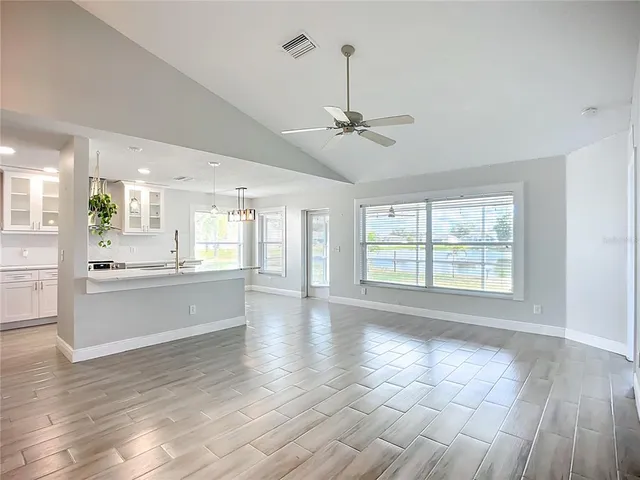 a large kitchen with granite countertop a large counter top and appliances