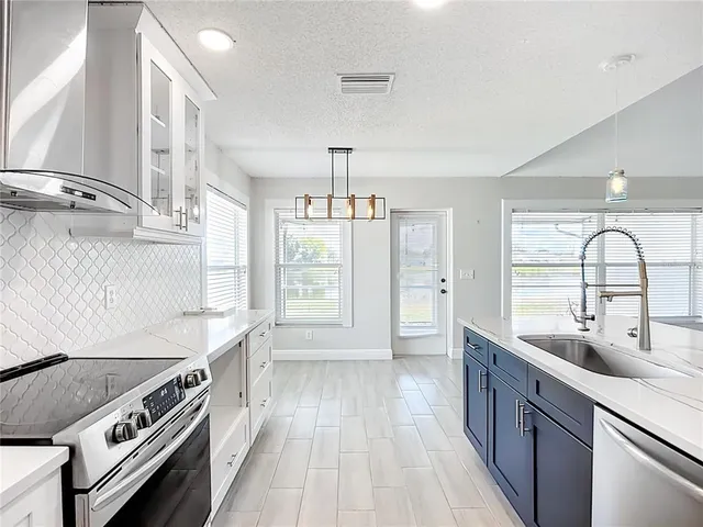 a kitchen with a sink and a stove top oven