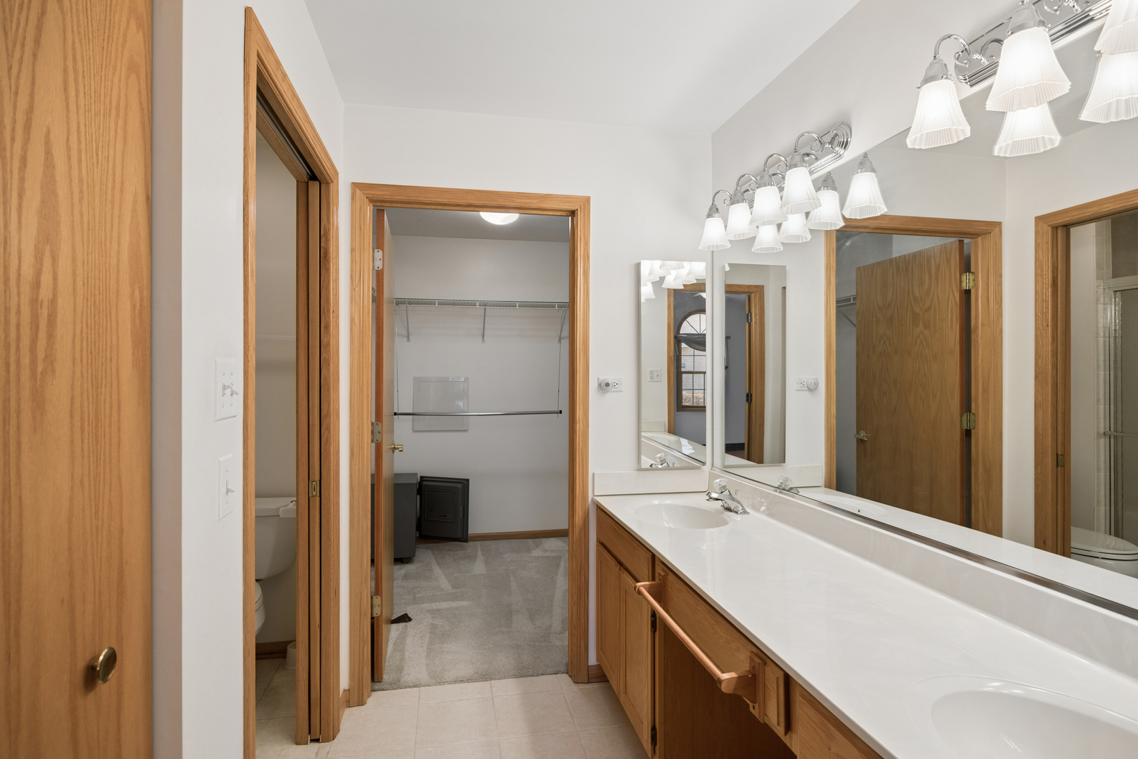 848 Havenshire Road, Unit 848 Naperville, IL 60565 - Photo 7 of 23 a bathroom with a double vanity sink and a mirror