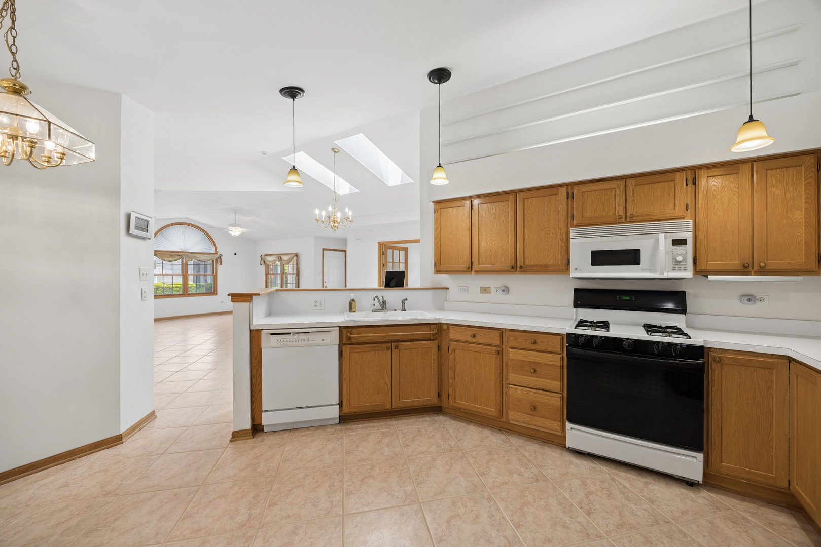 848 Havenshire Road, Unit 848 Naperville, IL 60565 - Photo 10 of 23 a kitchen with a sink a stove and cabinets