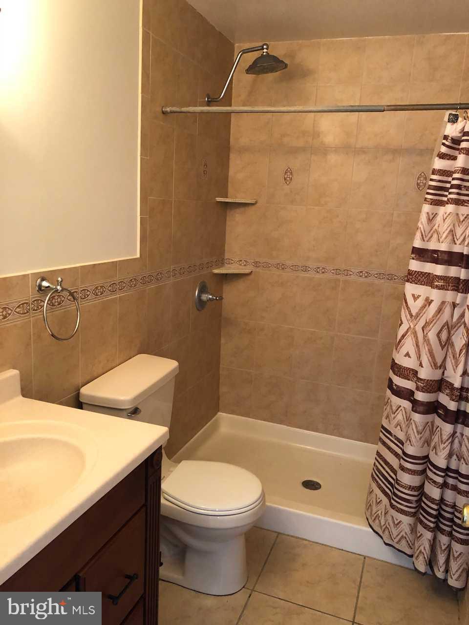 332 Cold Spring Place Dover, DE 19904 - Photo 23 of 30 a bathroom with a sink a toilet and shower