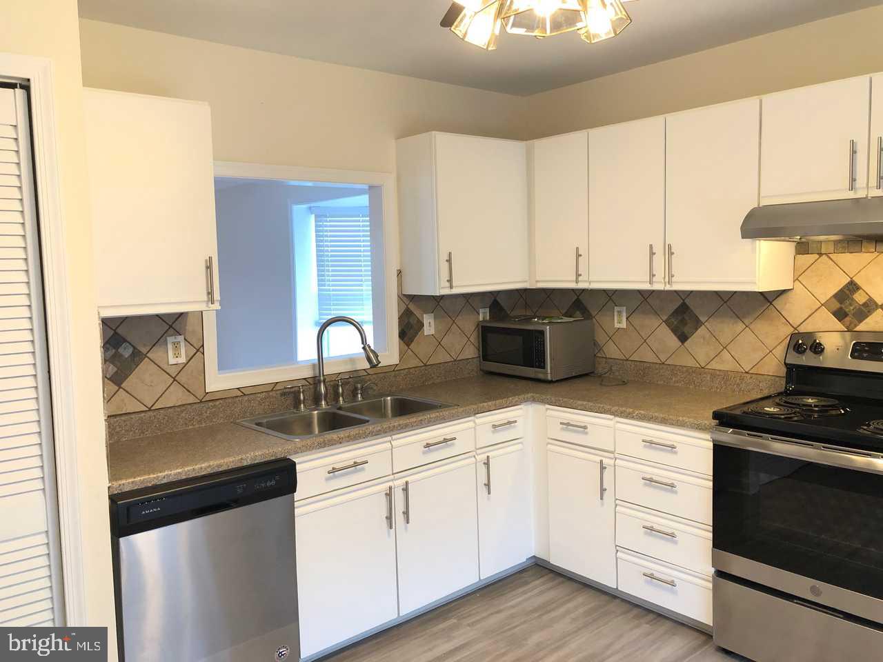 332 Cold Spring Place Dover, DE 19904 - Photo 30 of 30 a kitchen with granite countertop white cabinets and white appliances