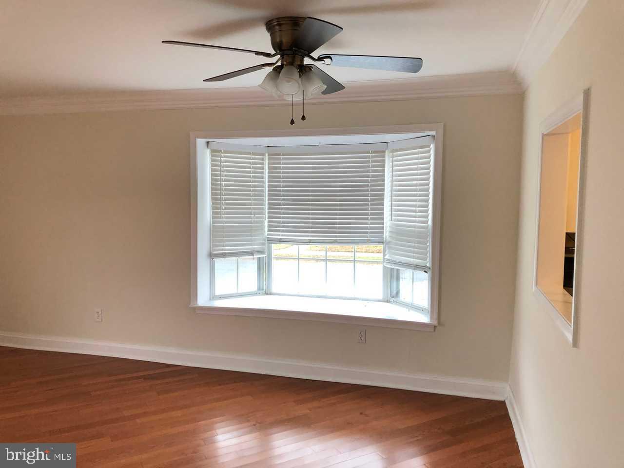 332 Cold Spring Place Dover, DE 19904 - Photo 6 of 30 a view of an empty room with wooden floor and a window