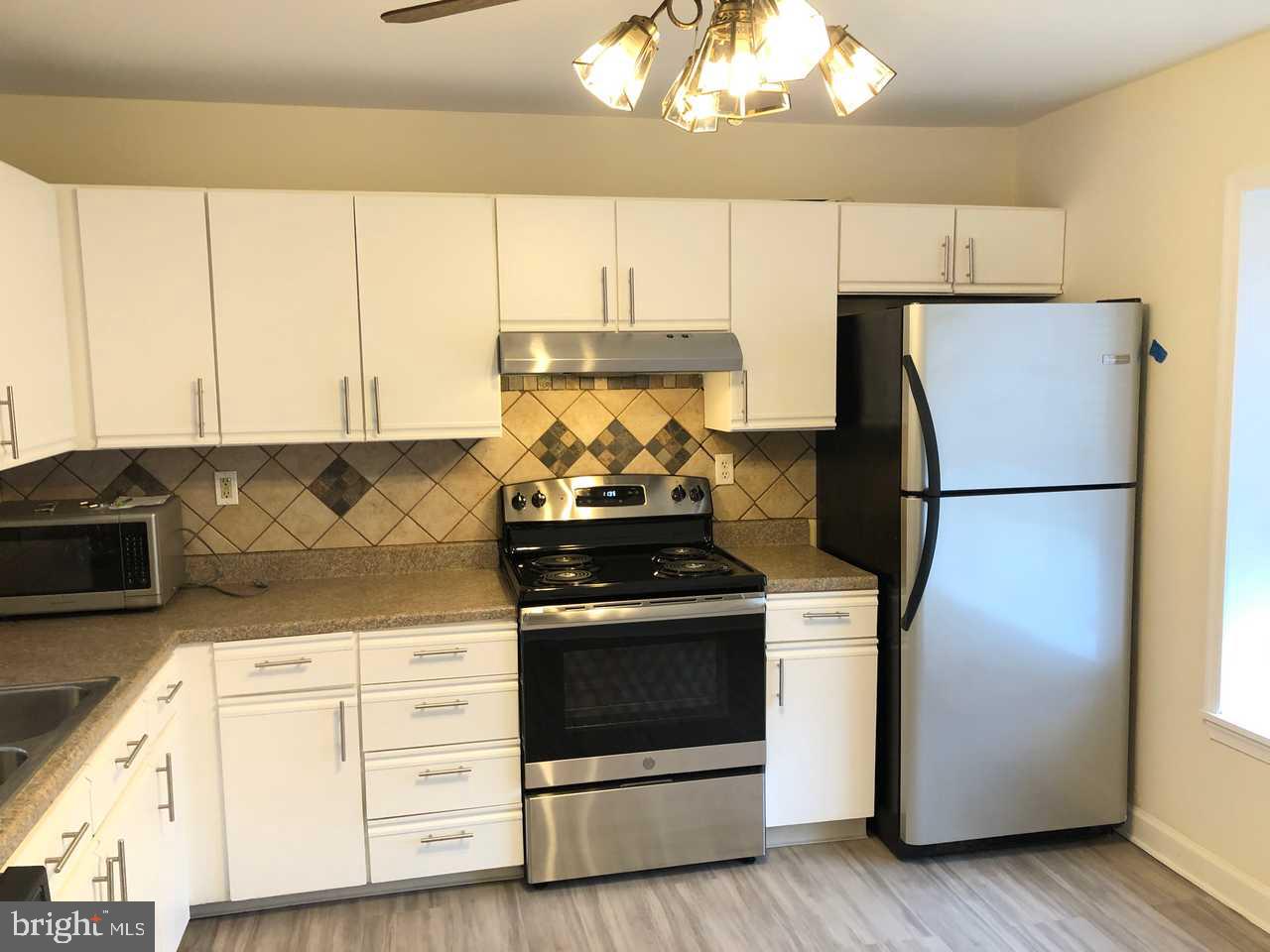 332 Cold Spring Place Dover, DE 19904 - Photo 10 of 30 a kitchen with stainless steel appliances granite countertop a stove a refrigerator and a microwave