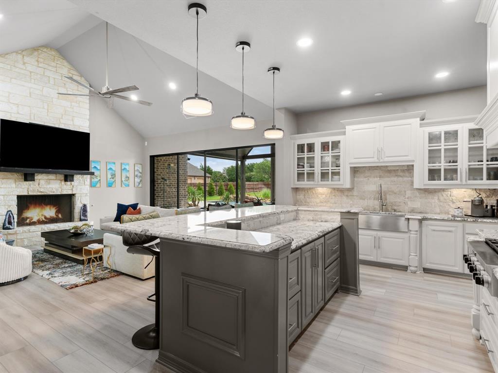 111 Old Base Road Aurora, TX 76078 - Photo 12 of 38 Updated kitchen with ample cabinetry, modern hardware, generous counter space, and views of the backyard