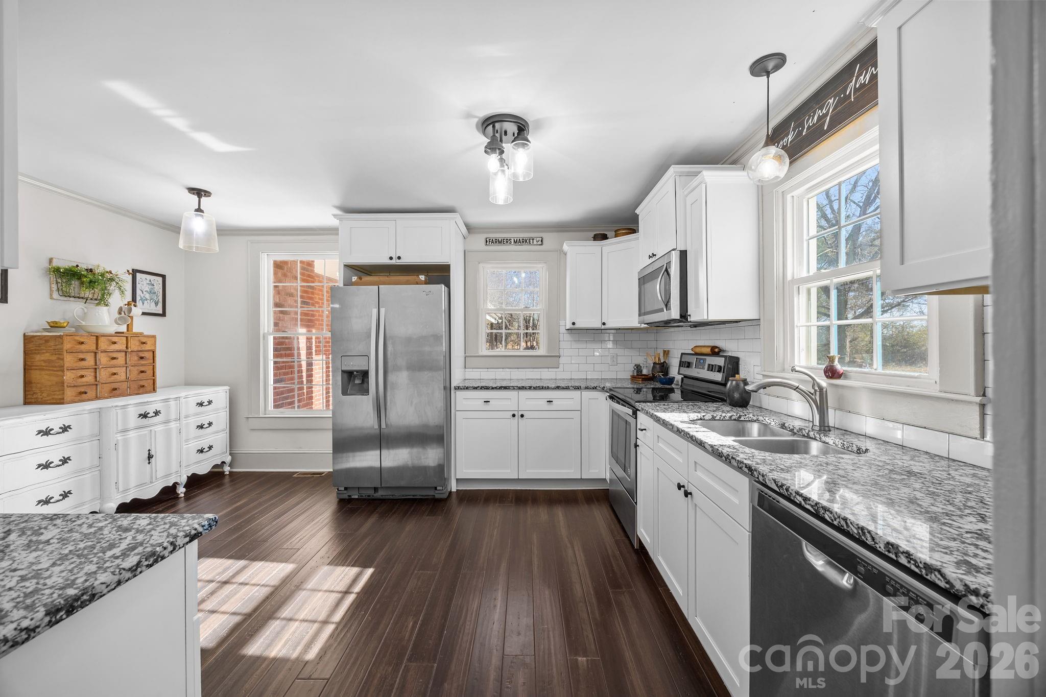 455 Eudy Road China Grove, NC 28023 - Photo 11 of 32 a kitchen with granite countertop a stove oven and sink