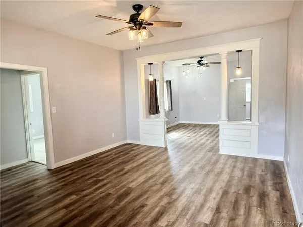 a view of empty room with wooden floor