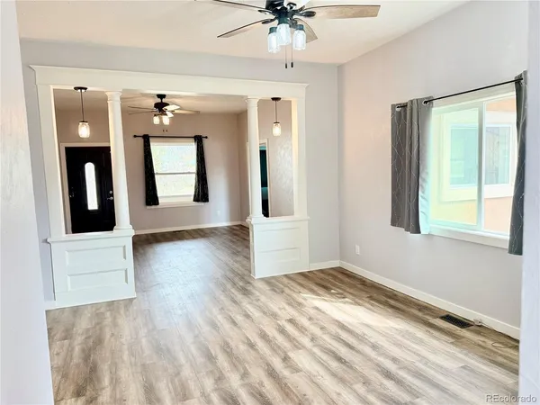 wooden floor in an empty room with a window