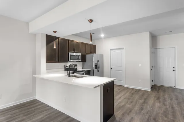 a kitchen with a sink appliances and cabinets
