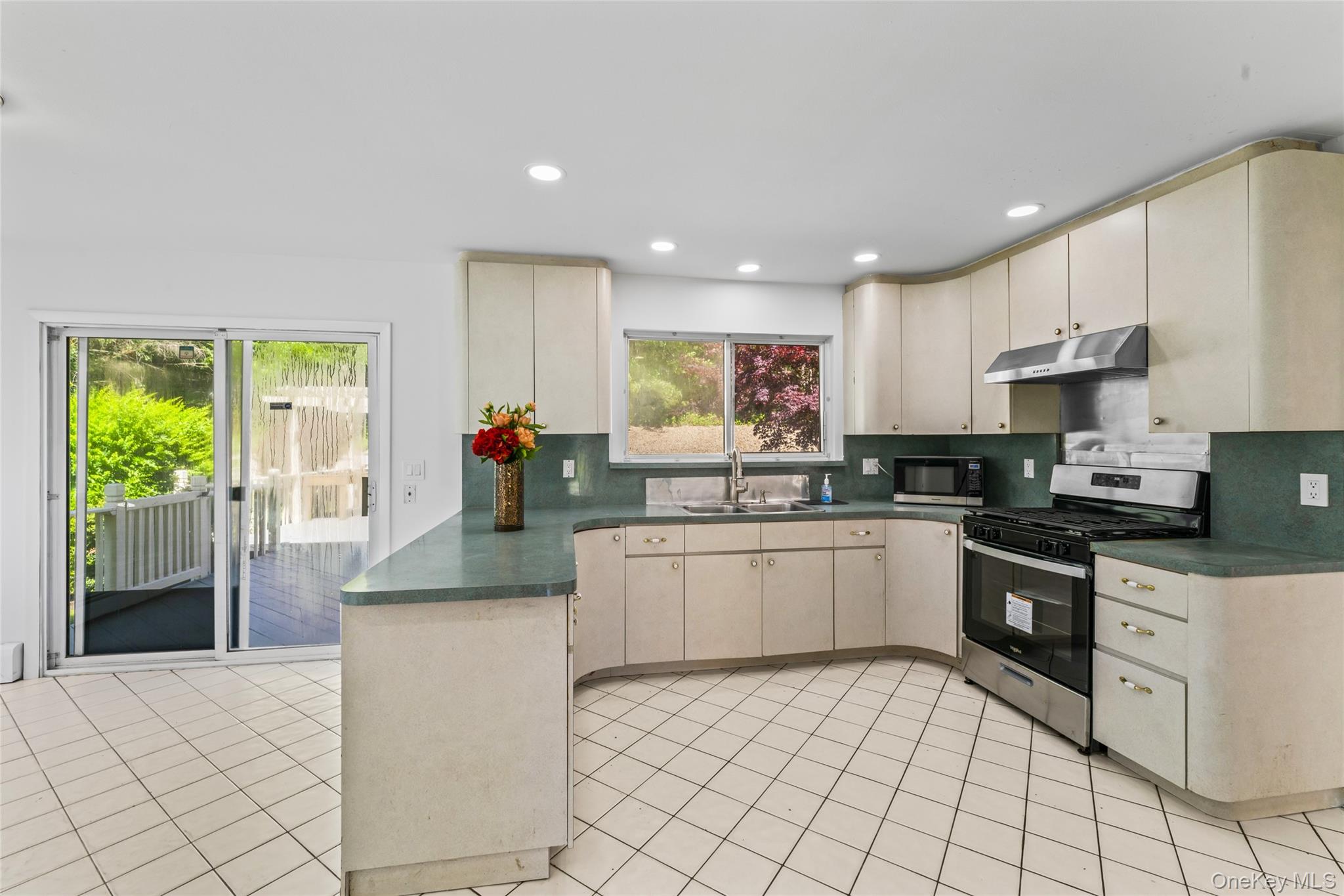 126 Bagatelle Road Melville, NY 11747 - Photo 19 of 50 a kitchen with a sink cabinets and window