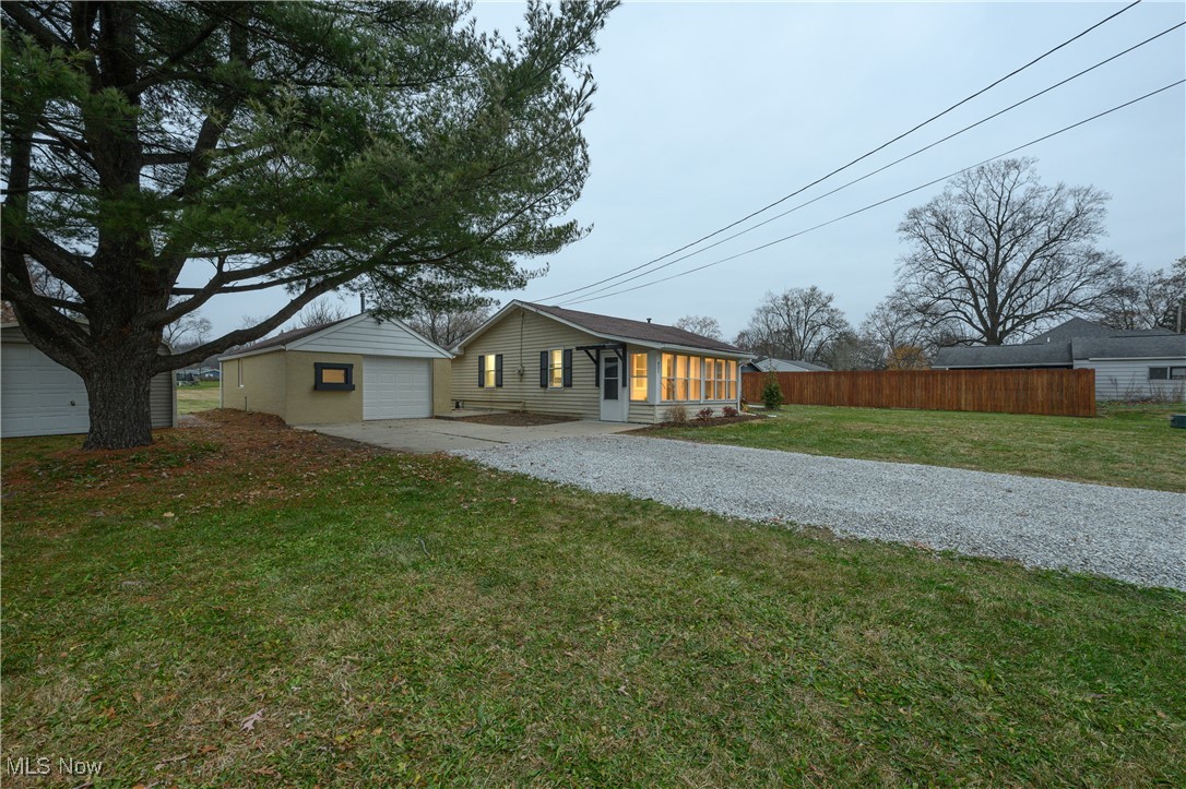 451 Yager Road Clinton, OH 44216 - Photo 23 of 25 View of front of house with driveway, a garage, and a patio