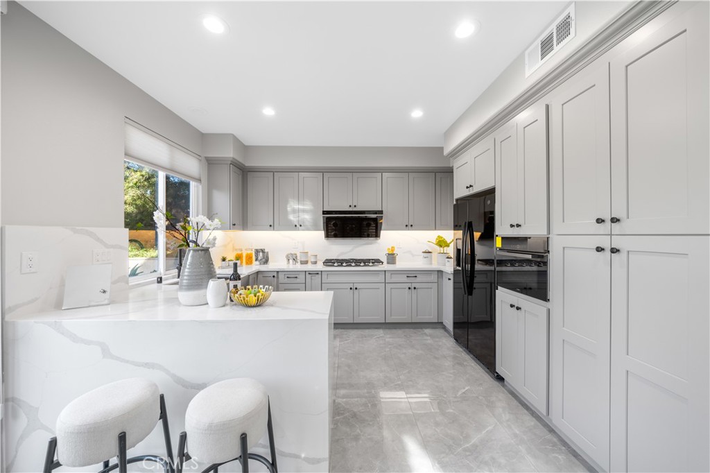 53 Middleton Irvine, CA 92620 - Photo 10 of 41 a kitchen with stainless steel appliances granite countertop a refrigerator sink stove and microwave