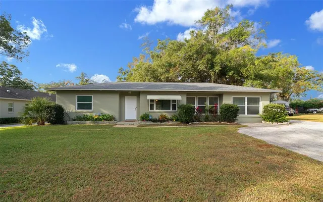 a front view of house with yard and green space