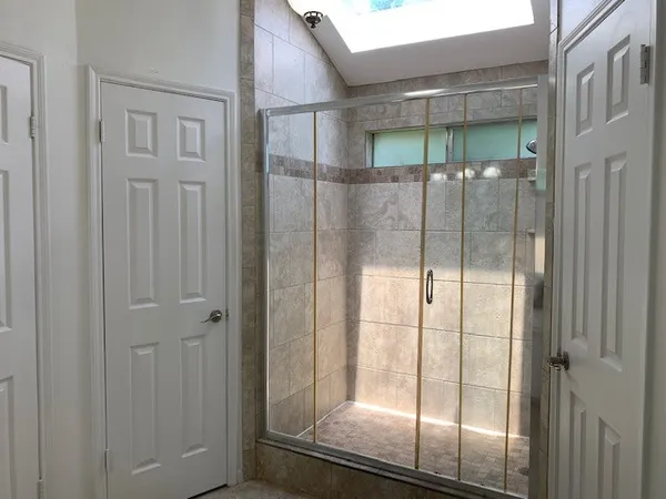 a bathroom with a glass shower door
