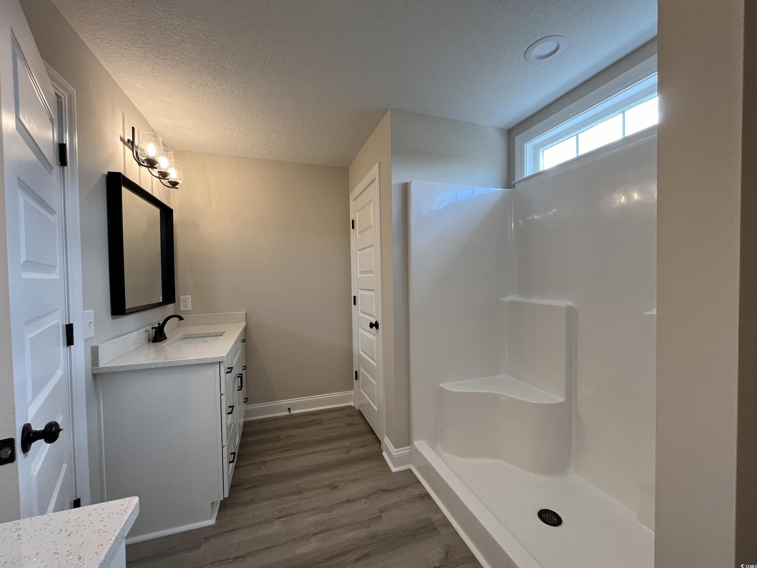 8229 Kerl Road Aynor, SC 29511 - Photo 11 of 19 Bathroom featuring walk in shower, vanity, a textu