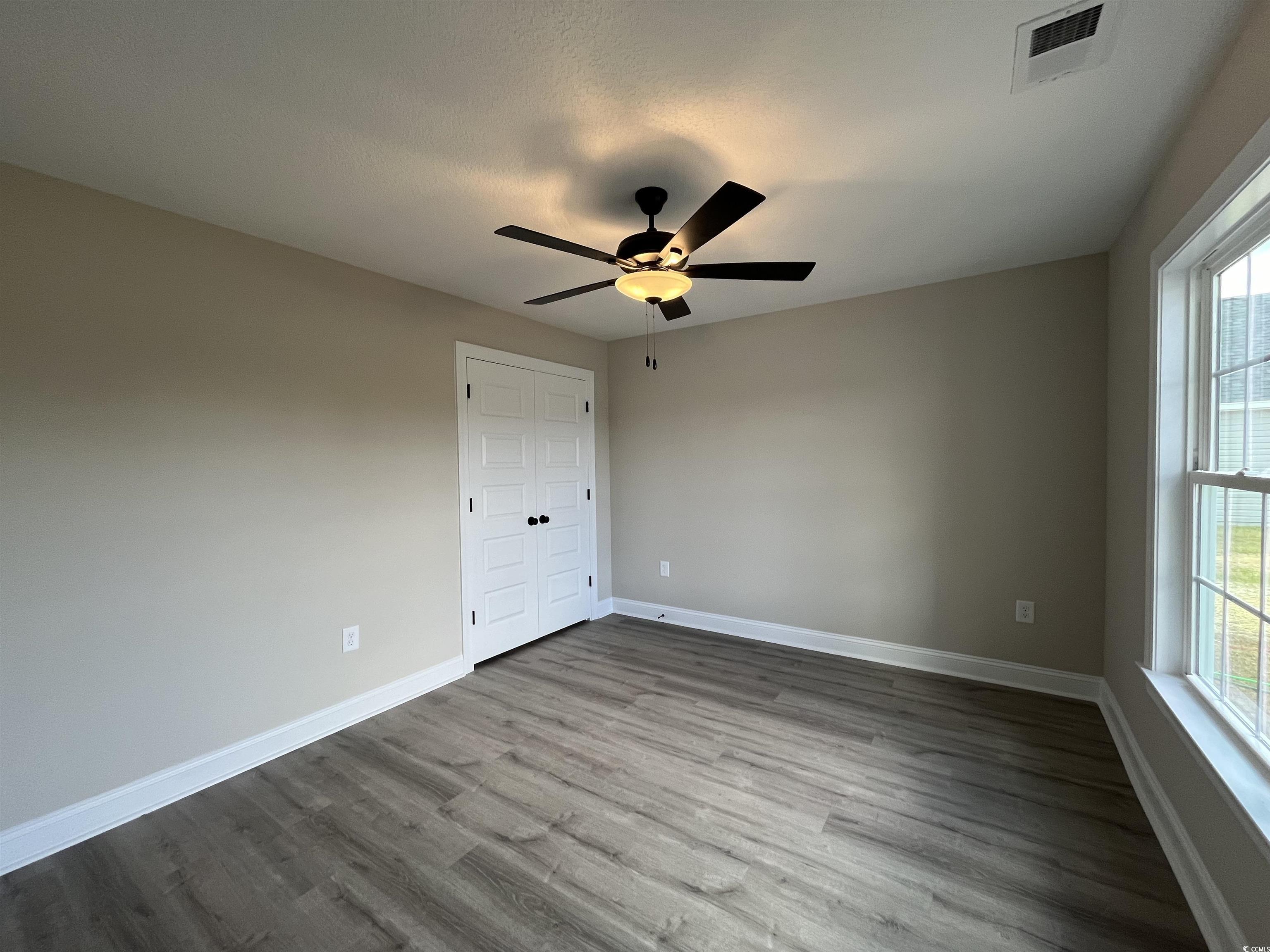 8229 Kerl Road Aynor, SC 29511 - Photo 14 of 19 Spare room with ceiling fan, wood-type flooring, a