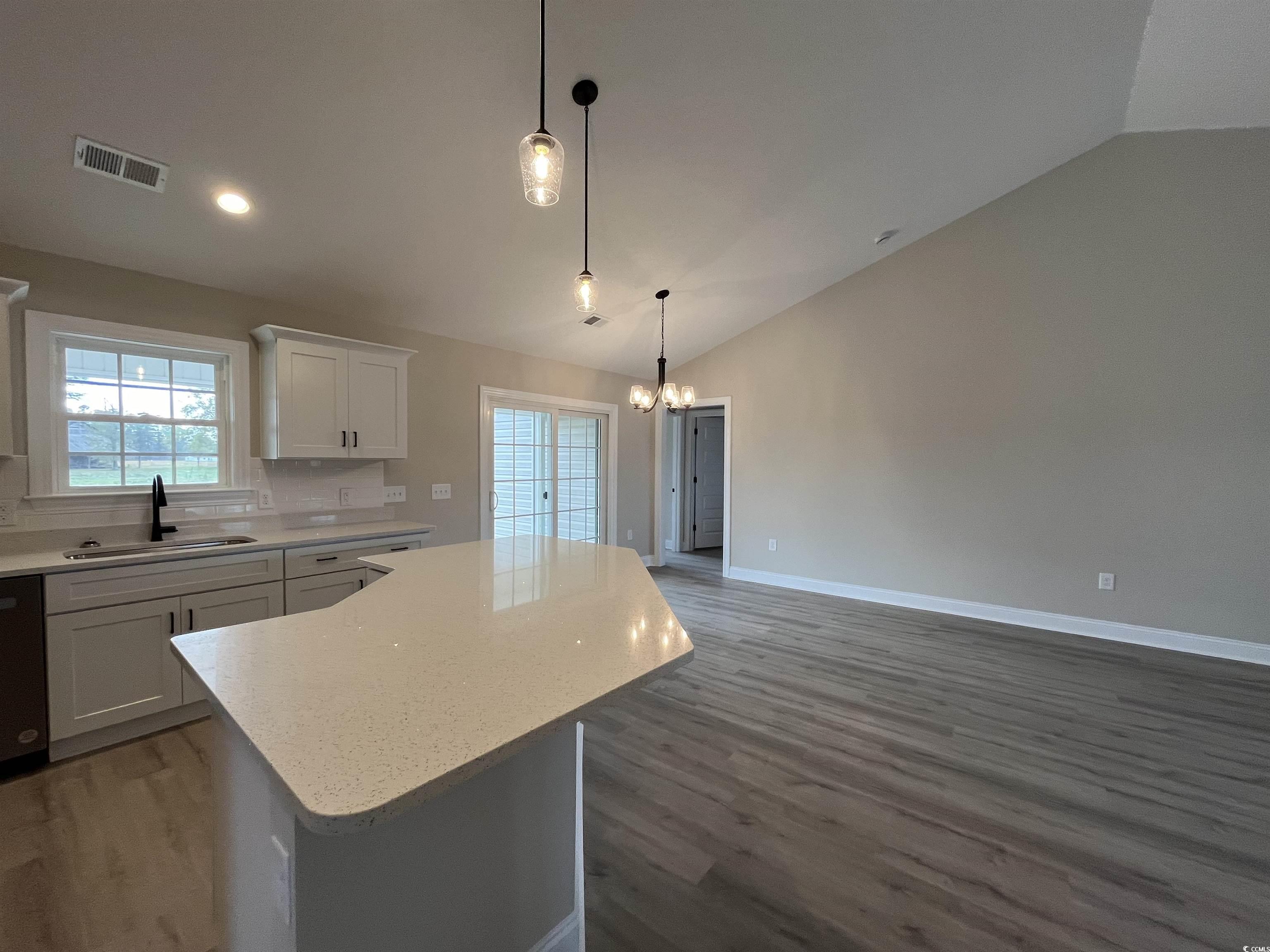 8229 Kerl Road Aynor, SC 29511 - Photo 8 of 19 Kitchen featuring white cabinetry, lofted ceiling,