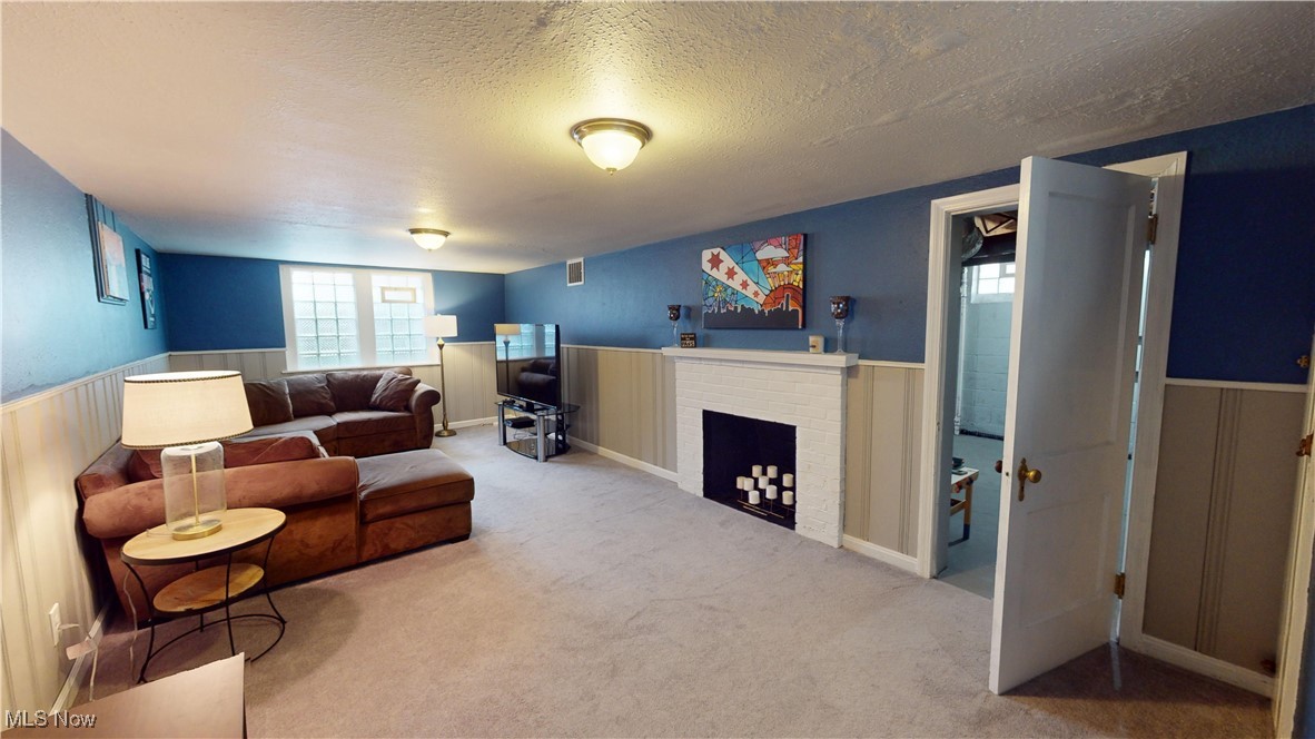 2412 Charney Road Cleveland, OH 44118 - Photo 37 of 48 Carpeted living room featuring a textured ceiling and a fireplace