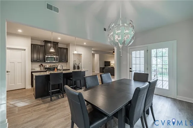 a bathroom with a sink a toilet a mirror a vanity and shower